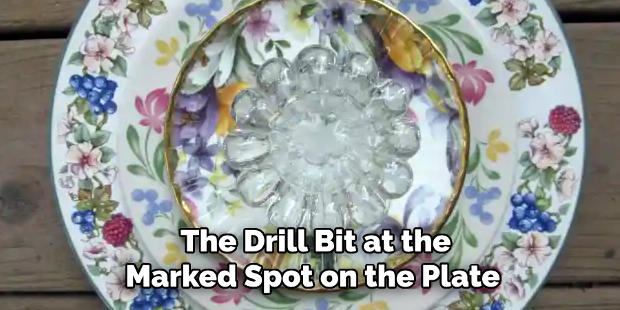 the Drill Bit at the
Marked Spot on the Plate