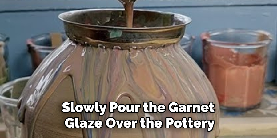 Slowly Pour the Garnet Glaze Over the Pottery