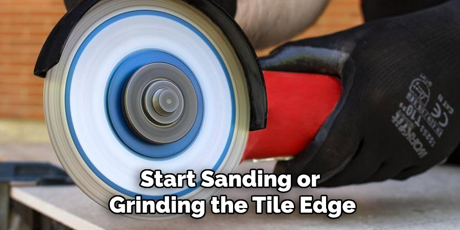 Start Sanding or Grinding the Tile Edge