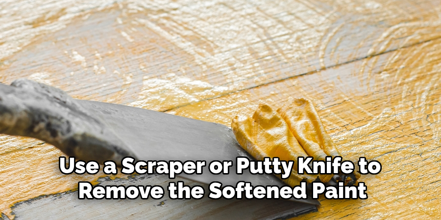 Use a Scraper or Putty Knife to Remove the Softened Paint